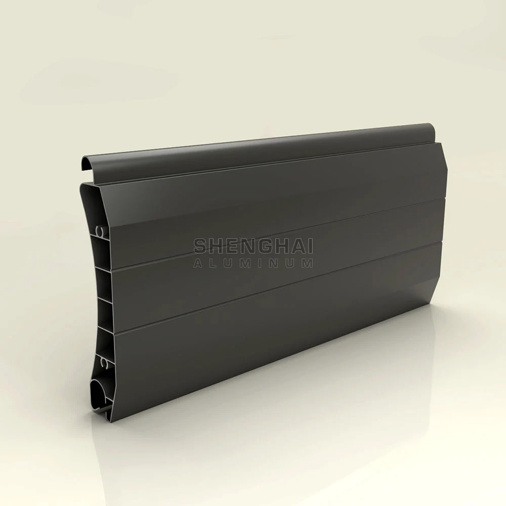 Heavy-duty dark grey multi-chamber extruded aluminum shutter profile for large industrial openings.